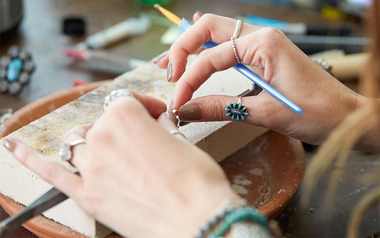 Close up of Reagan making jewelry  